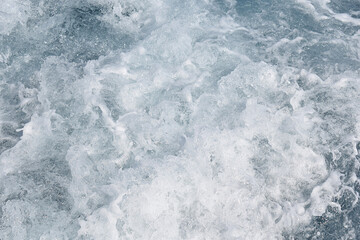 Foamed seawater behind the stern of a sailing ship