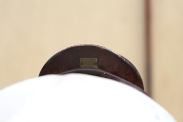 On the back of the horse, a brown leather saddle