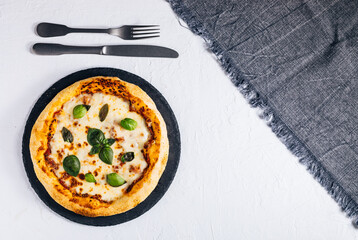 Traditional Margherita Pizza with basil, tomato, olive oil, mozzarella on a rustic background