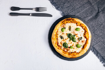 Traditional Margherita Pizza with basil, tomato, olive oil, mozzarella on a rustic background
