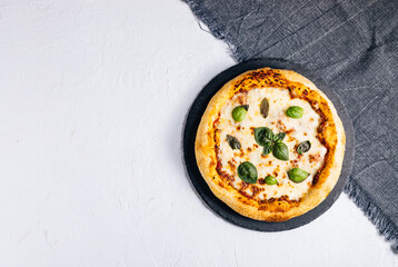 Traditional Margherita Pizza with basil, tomato, olive oil, mozzarella on a rustic background