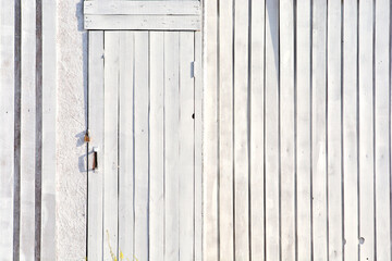 Country white wooden door in a wooden wall. Barn entrance.
