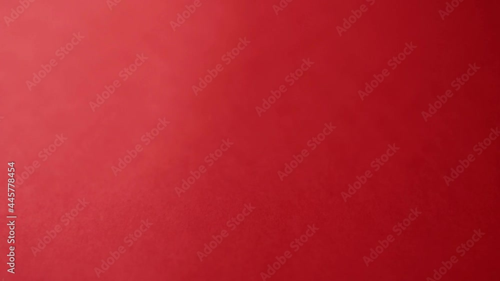Poster a closeup view of a person taking a red flashlight from a red table in hd