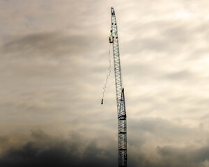 man bungee jumping from a high crane