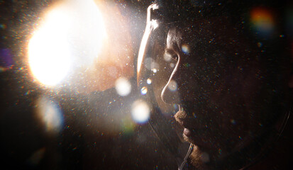 Double exposure portrait of futuristic astronaut in spacesuit. Astronomy conception. Distant...