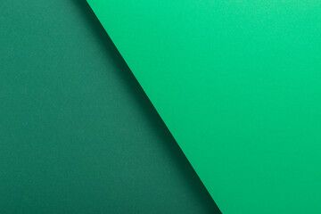 Green cardboard background design folded geometrically. Top view, flat lay