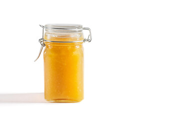 Homemade yellow jam in a jar on a white background. Fruit jam. Copy space.