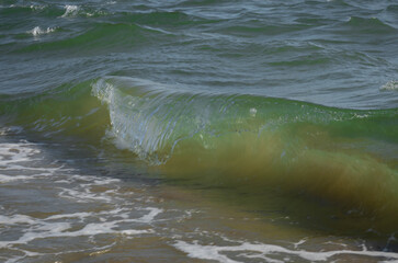 Colored sea waves with splashes and white breakers in Circeo park, Sabaudia, Italy