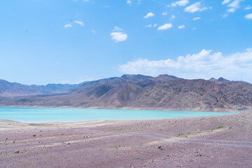 View of a mountain lake of birch color. Bartogay near the city of Almaty in Kazakhstan