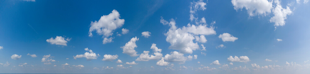 Naklejka na ściany i meble White loose clouds on a blue sky