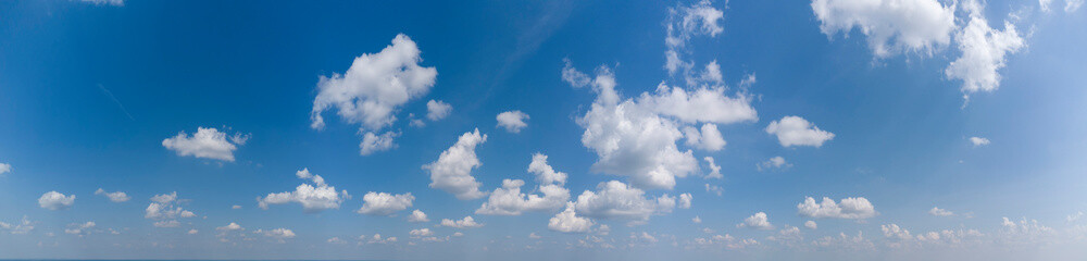 White loose clouds on a blue sky