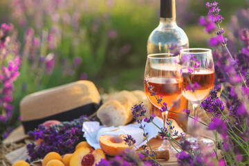 Wine in glasses. Picnic in the lavender field. Selective focus.