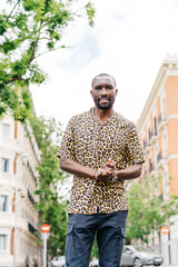 positive afro american stylish man in european city