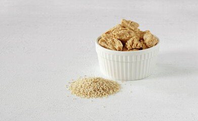 halva from sesame seeds in a bowl and the seeds lie nearly. Place for text