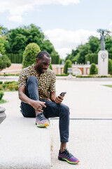 positive afro american stylish man in european city