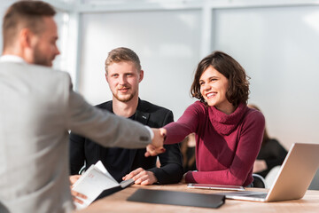 HR Manager shaking hands with young job seeker