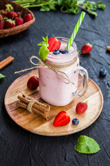Healthy smoothie of fresh summer berries. Creative atmospheric decoration