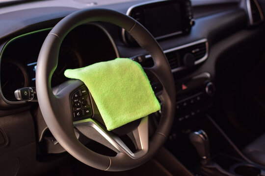 Interior de un vehiculo luego de una limpieza profesional. Volante, panel central, indicadores, detallado, autolavado, color negro.
