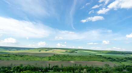 Fototapeta na wymiar Beautiful summer countryside landscape against the background of blue sky and white clouds