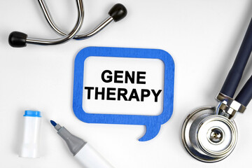 On the table is a stethoscope, a marker and a sign with the inscription - GENE THERAPY