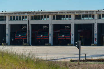 Fototapeta na wymiar A group of fire trucks parked in the garage and ready to call, to help with a fire. Emergency service at the airport.