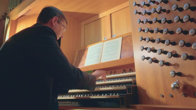 Organist plays music on church organ
