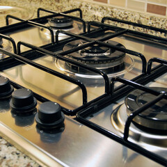 Modern clean kitchen and stainless steel chrome built-in gas oven