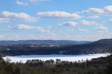 Stockbridge Bowl, also known as Lake Mahkeenac, in Massachusetts in winter with snow on the ground seen from a viewpoint known as "Olivia's Overlook"