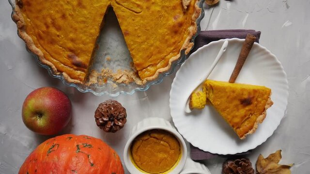 Homemade Pumpkin Dough Pie With Baked Goods On Wooden Tables, Apples And Pumpkins. Traditional American Dessert. View From Above