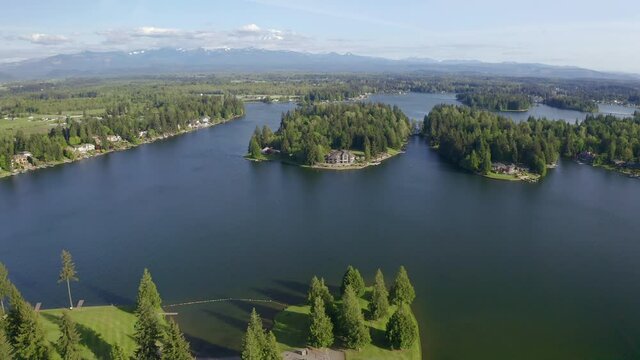 Beautiful View of a String of Islands on a Lake with a Snow-capped Mountain on the Horizon