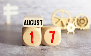 August 17st. Day 17 of month, daily calendar on white table with reflection, with light blue...