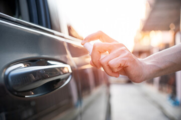 Close up hand women use Alcohol spray clean hand opening the car door  protection and cleaning concept of transportation