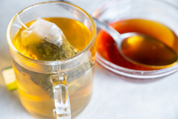 Raw honey and glass mug of tea