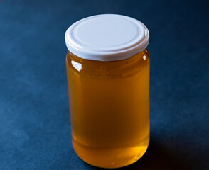 a jar full of honey alone with antique blue background