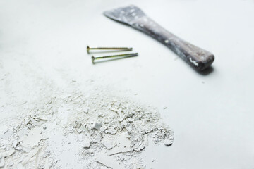 Spatula nails and dried crushed putty lime on white background