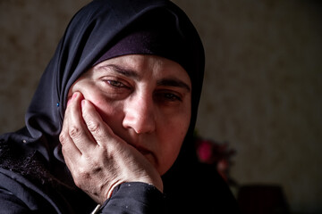 Muslim woman praying for Allah with her feelings of devotion and commitment on her face
