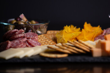 Full platter with meats, cheese, nuts, crackers, olives and an apricot spread