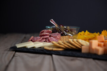 Full platter with meats, cheese, nuts, crackers, olives and an apricot spread