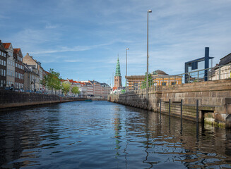 Fototapeta premium Frederikholms Canal with former Old St Nicholas Church Tower on Background - Copenhagen, Denmark