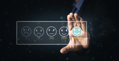 Customer Service and Satisfaction Concept Businessmen touch the virtual screen on happy smiley icons to achieve service satisfaction and feedback with excellent rated reviews.