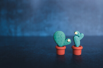 Cactus shaped erasers on a dark background. Horizontal image. Teaching concept. Copy-space