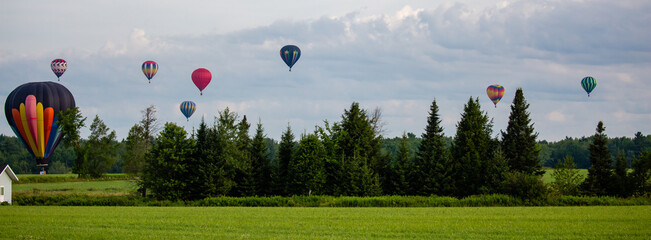 Near Wausau, Wisconsin, USA, July 10, 2021, Taste N Glow Balloon Fest. Hot air balloons fill the sky in central Wisconsin
