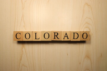 The word Colorado was created from wooden letter cubes. Cities and words.