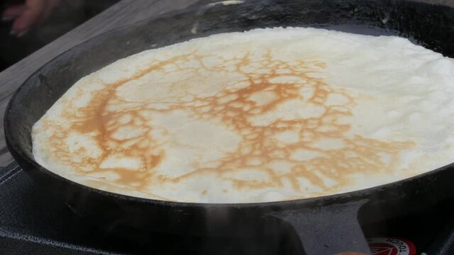 A large pancake pan in which the dough is fried for future crepes. Maslenitsa holiday, a vital celebration of the meeting of spring among the Slavs, a street food festival