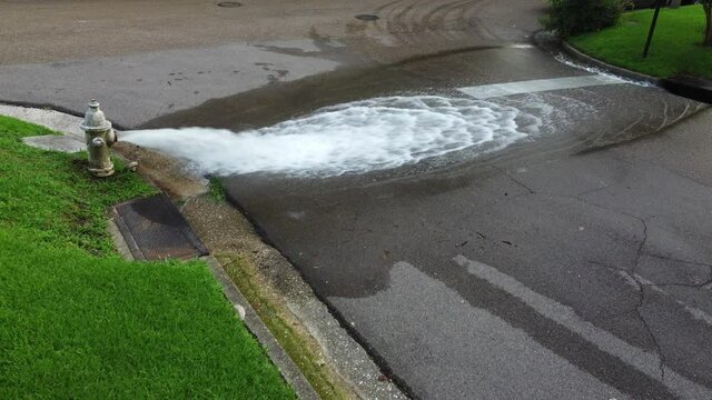 Open fire hydrant wasting water onto the street