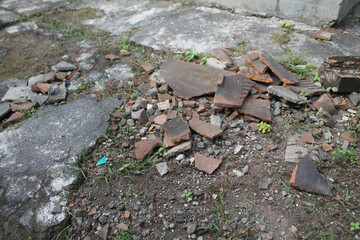 tile shards scattered on the dirty ground