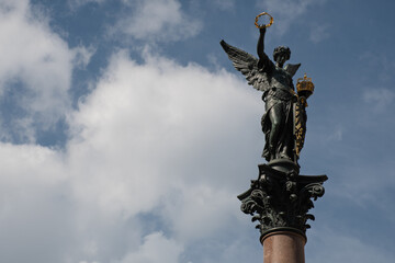 Fototapeta na wymiar Statue of Victory, designed by Johann Rößner, on top of the Kriegerdenkmal Köpfleinsberg in Nuremberg, Germany, a 19th-century victory column memorial for the fallen of the 1870/71 Franco-Prussian War