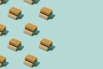 Pattern with neutral beige clean sponges for home cleaning on blue background. Banner for your site, concept for laundry, cleaning service, advertising, spring regular cleaning day, copy space