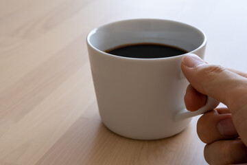 コーヒーカップを持つ手
