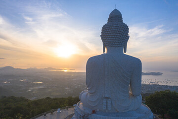 aerial view glare of sunrise on the shoulder of Phuket big Buddha.Phuket Big Buddha is one of the island most important and revered landmarks on the island..image for travel and culture concept.. © Narong Niemhom